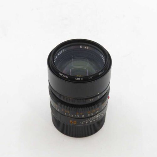 Camera lens with a black exterior, featuring a Hoya UX II UV filter.