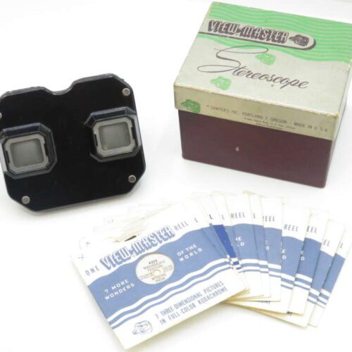 Vintage View-Master stereoscope with a collection of reels and original packaging.