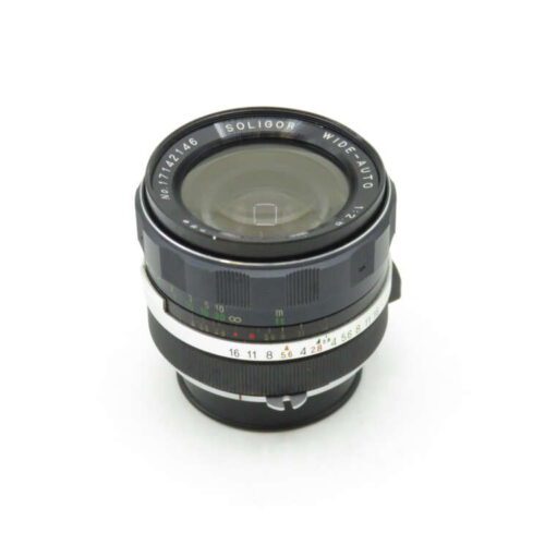 Camera lens labeled "Soligor Wide Auto" with a focal length of 28mm and aperture of f/2.8, featuring distance and aperture markings.