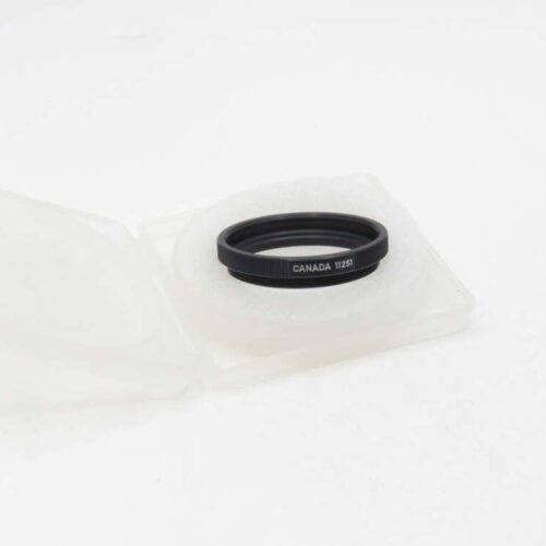 A small black ring with "CANADA 11251" inscribed on it, resting in a white foam case with an open lid.