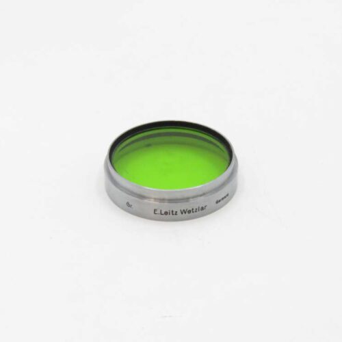 Green E.Leitz Wetzlar camera filter on a white background.