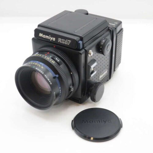 Mamiya RZ67 camera with lens cap placed nearby.