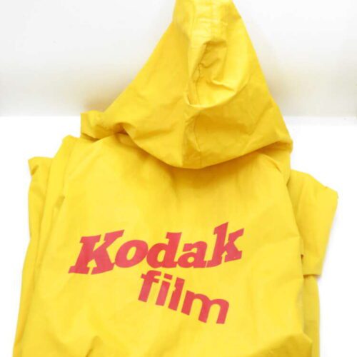 Yellow Kodak film rain poncho with a hood.