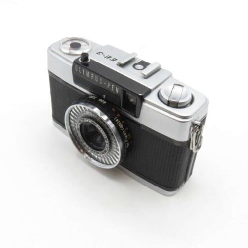 Vintage Olympus Pen EE-3 camera with a silver body and black textured grip, featuring a compact lens and built-in light meter.