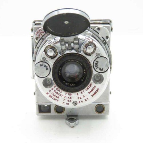 Le Coultre Compass Camera with a circular lens and various dials and settings, featuring a metallic finish.
