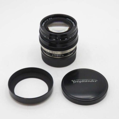 Voigtländer camera lens with cap and hood on a white background.