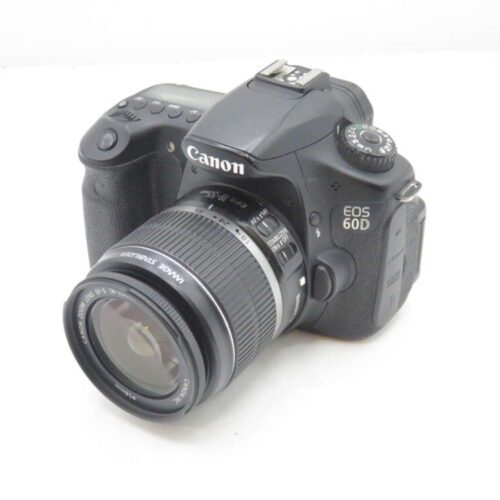 A Canon EOS 60D DSLR camera with an attached 18-55mm image stabilizer lens, displayed on a plain surface.