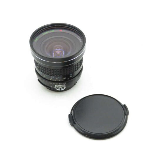 A Tokina AT-X 17mm wide-angle camera lens with a black lens cap lying beside it on a white background.