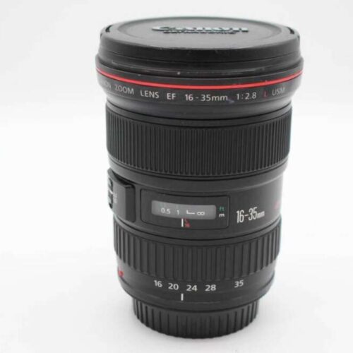 A Canon EF 16-35mm f/2.8 L USM zoom lens with a lens cap.