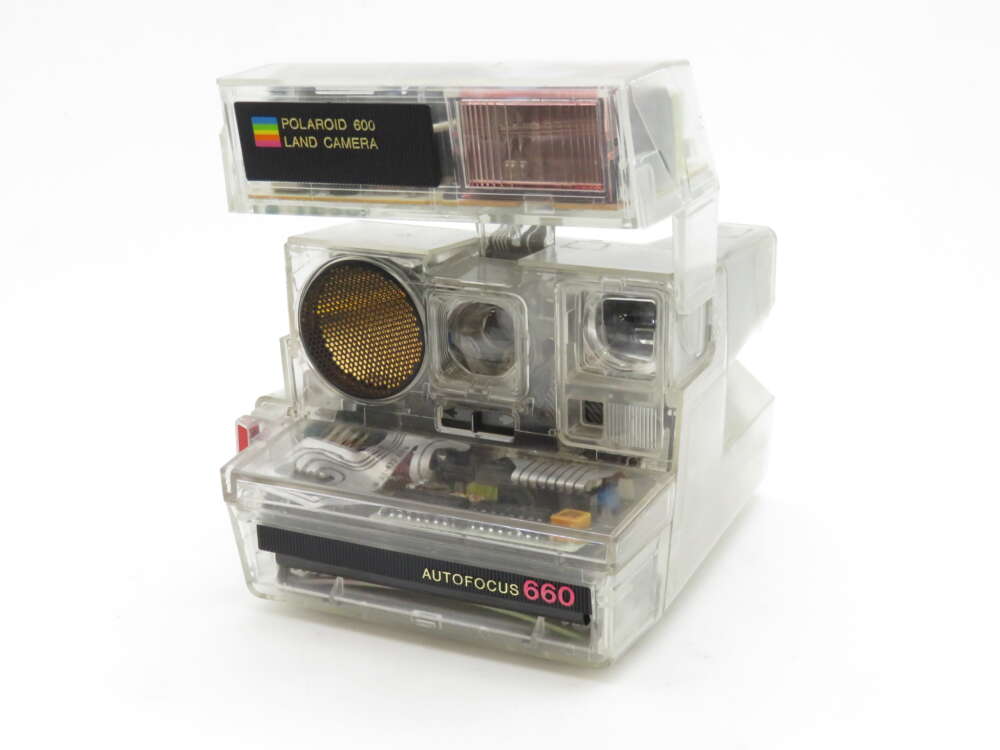 IMG_0635 A vintage Polaroid 600 Land Camera with clear casing exposing its internal components, featuring an autofocus label and a classic design.