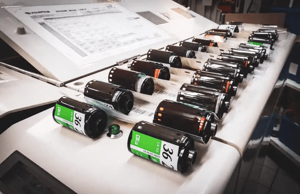 Multiple rolls of undeveloped film sit on a flat surface for film developing Adelaide