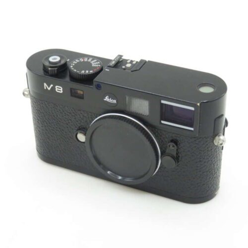 Black Leica M8 camera with textured body and lens cap, featuring a top dial and viewfinder.