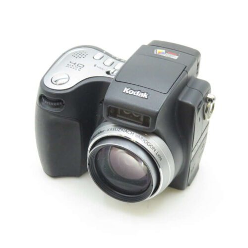 A Kodak digital camera with a prominent lens and a black and silver design, featuring various control buttons on the top panel.