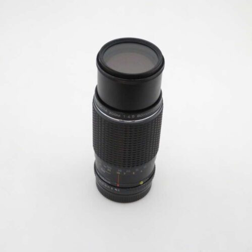 A black telephoto camera lens with a zoom function, featuring various settings and focal length markings, displayed against a plain white background.