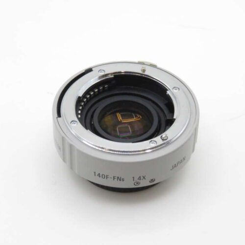 A camera lens adapter with the markings '140F-FNs 1.4X' and 'JAPAN' on its silver casing, set against a plain white background.