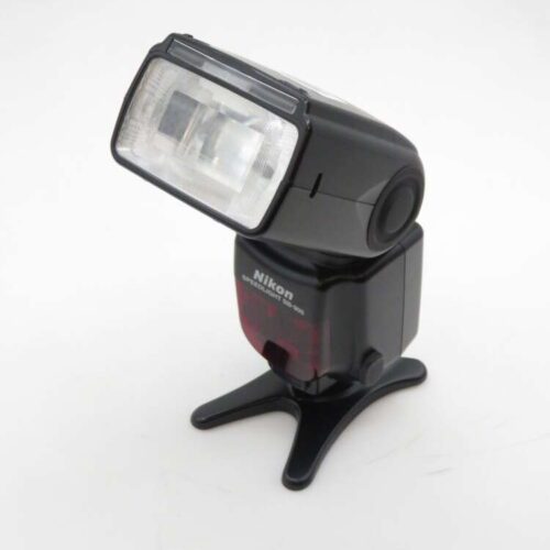 Black Nikon Speedlight SB-900 flash unit mounted on a stand, angled slightly upward against a plain white background.
