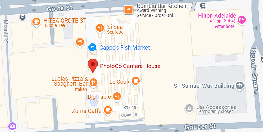 A map displaying a section of Grote Street with various businesses marked, including Photoco Camera House, Lucias Pizza & Spaghetti Bar, Cappo's Fish Market, and Hilton Adelaide. Nearby streets include Moonta Street and Victoria Square.