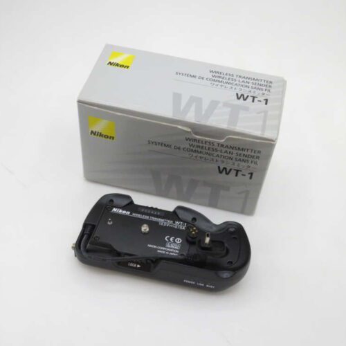 A Nikon wireless transmitter WT-1 with its original box, showing the device's label and control features on a plain white background.