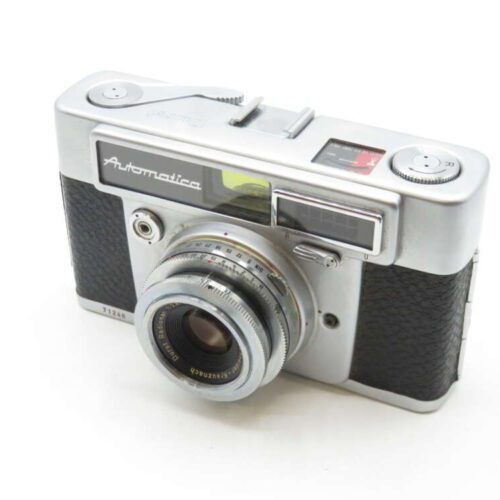 A vintage Rectaflex Automatica camera with a metallic body and textured black grip, featuring a prominent lens and clear viewfinder on the front.