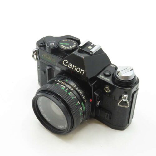 A vintage Canon AE-1 film camera with a 50mm lens attached, displaying its black body with silver accents, buttons, and dials on top.