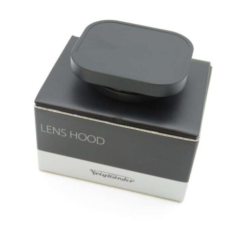 A black lens hood on top of a box labeled 'Lens Hood,' with the brand name 'Voigtländer' displayed on the lower part of the box.