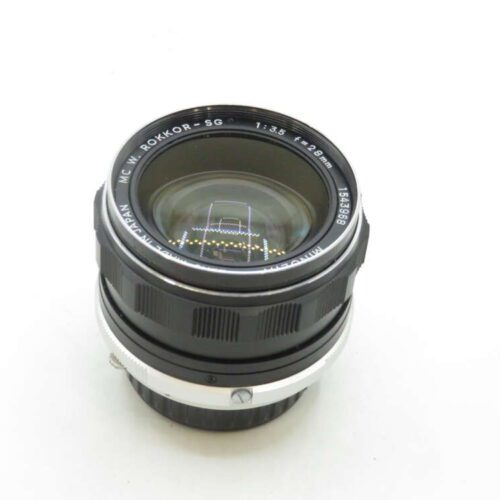 A Minolta MC W. Rokkor-SG 28mm f/3.5 camera lens with a metal mount and black focusing ring, set on a white background.