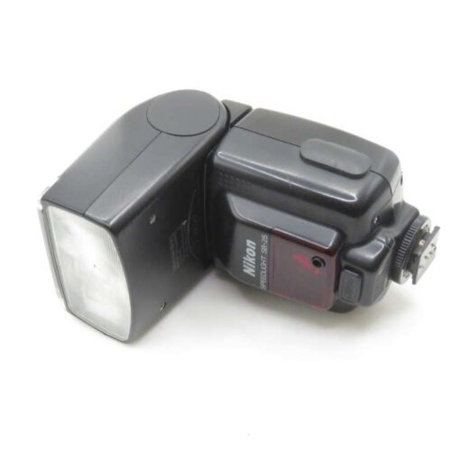 A Nikon Speedlight SB-25 camera flash lying on its side, showing the flash head and control panel with the Nikon branding visible.