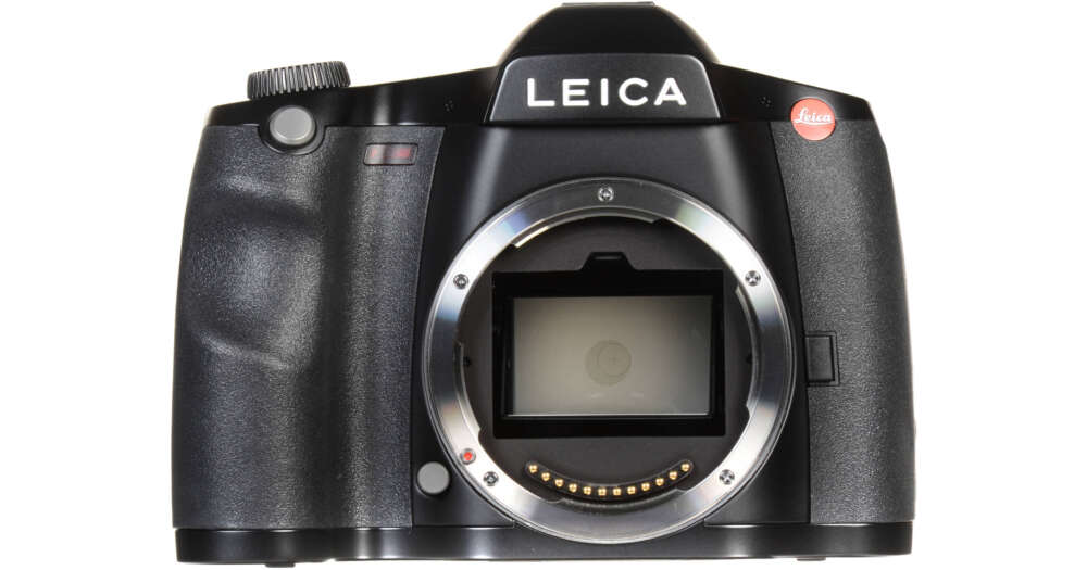 Front view of a Leica medium format digital camera body without a lens, showcasing its large sensor opening and control dials.