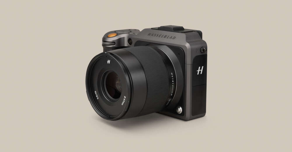 A Hasselblad X1D camera with a large lens, featuring a compact rectangular body and a prominent "H" logo on the lens cap, set against a plain background.