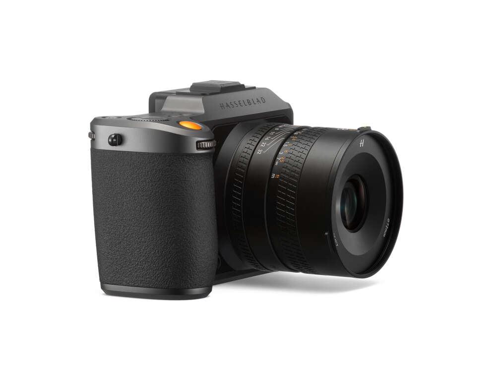 A high-end digital camera with a large lens and a textured black grip, displaying a premium design.
