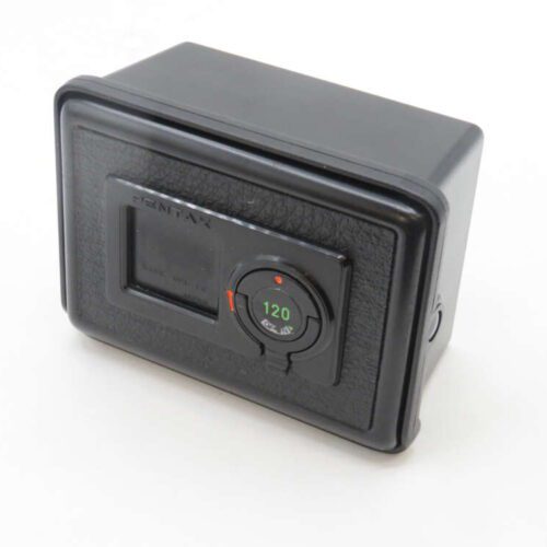 A black Pentax camera accessory with a leather-textured finish and a central dial labeled '120' in green, likely for film format, on a white background.