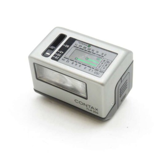 A silver Contax TLA 200 flash unit with a rectangular shape, featuring settings dials and a light indicator on top, with the flash head visible on one side.