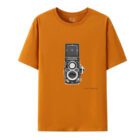 An orange T-shirt featuring a print of a vintage camera on the front.