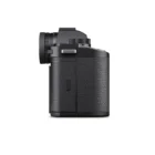 Side view of a black camera body with a textured grip and a visible lens mount.
