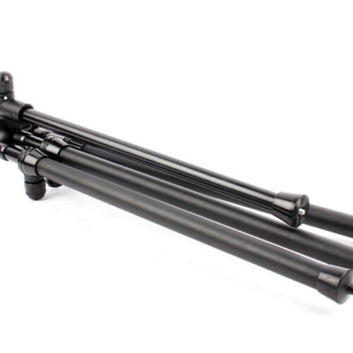 A black, folded camera tripod with three telescopic legs and rubber feet, lying on a white background.