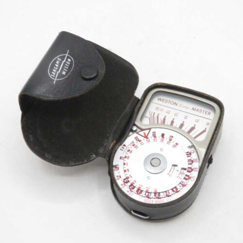 A vintage Weston Euro-Master light meter in a black leather casing, with dials and measurement markings visible on its face.