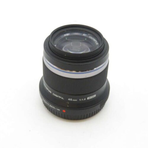 A black Olympus 45mm f/1.8 digital camera lens with a textured focus ring, shown against a plain white background.