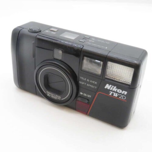 A Nikon TW2D compact film camera featuring a 35/70mm macro lens and a flash, displayed on a white surface.