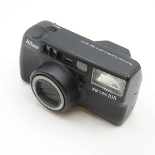 A black Nikon TW Zoom 105 film camera with a distinctive boxy design, featuring a protruding lens, viewfinder, and flash on the front, resting on a white surface.
