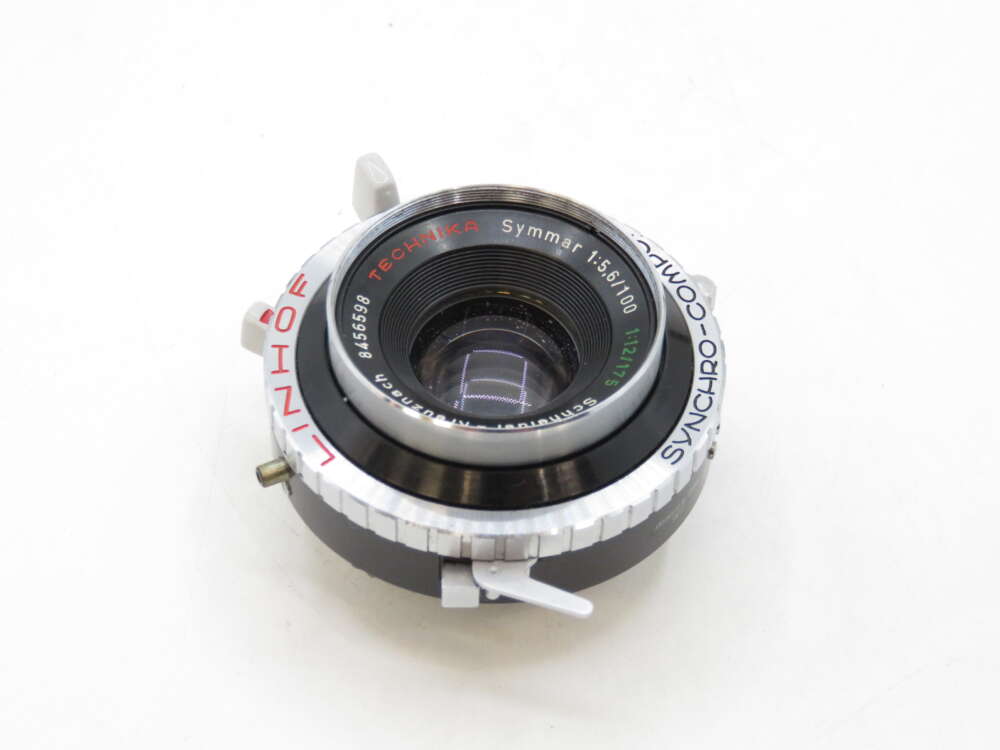 IMG_2232 A close-up of a Linhof Technika Synchro-Compur camera lens with visible dials and inscriptions.