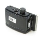A vintage Graflex "23" Graphic roll film holder designed for 120 film with a price tag of $125, displaying a black exterior with intricate mechanical details.