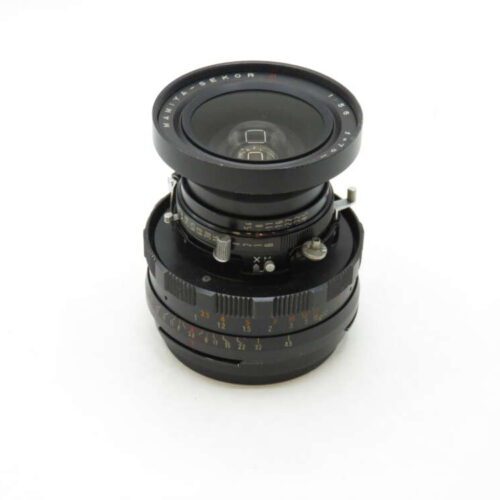A Mamiya-Sekor camera lens with aperture and focus rings, displayed against a white background.