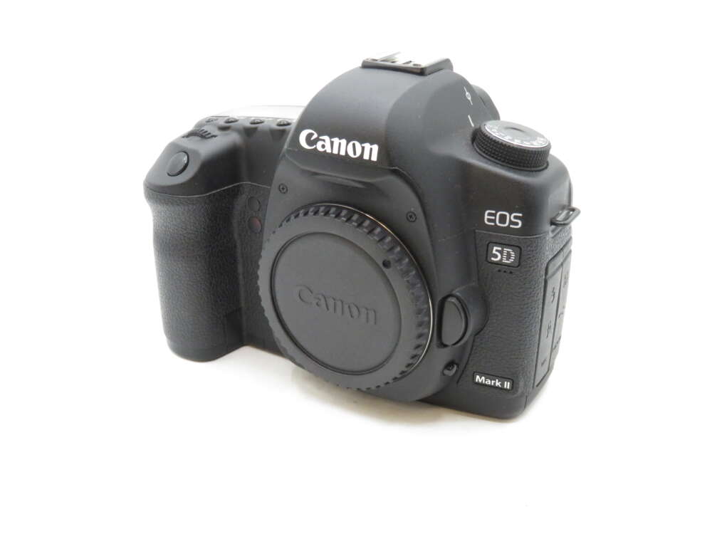 IMG_3046 A Canon EOS 5D Mark II DSLR camera with a body cap, viewed from an angle.