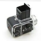 A vintage black and silver medium format camera with a pop-up viewfinder, featuring multiple dials and a silver lens.