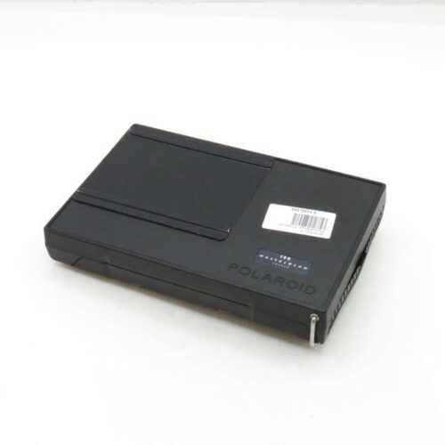 A black Polaroid SX-70 film cartridge with a white label displayed on a plain background.