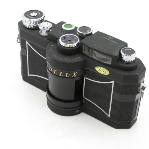 A vintage Widelux camera with a black body and silver dials, showcasing a distinctive rounded lens design.