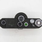 Top view of a vintage black camera with dials and settings for various controls.
