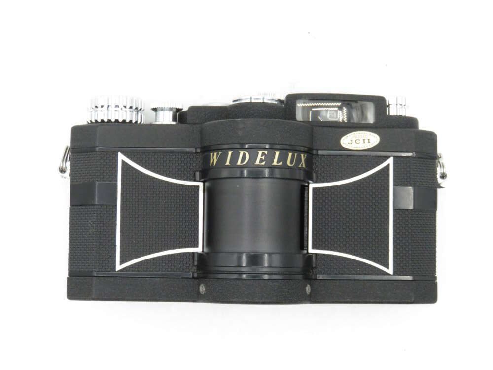 A black Widelux film camera with a distinctive cylindrical lens and silver detailing.