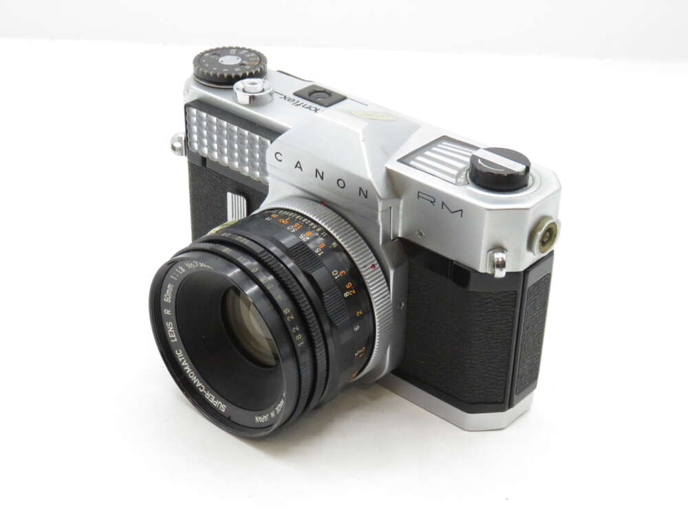 IMG_3109 A vintage Canon RM film camera with a silver and black body and a prominent lens.