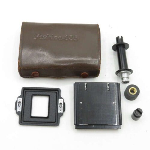 Set of Yashica 635 camera accessories including a brown leather case, film holder, and various small parts.